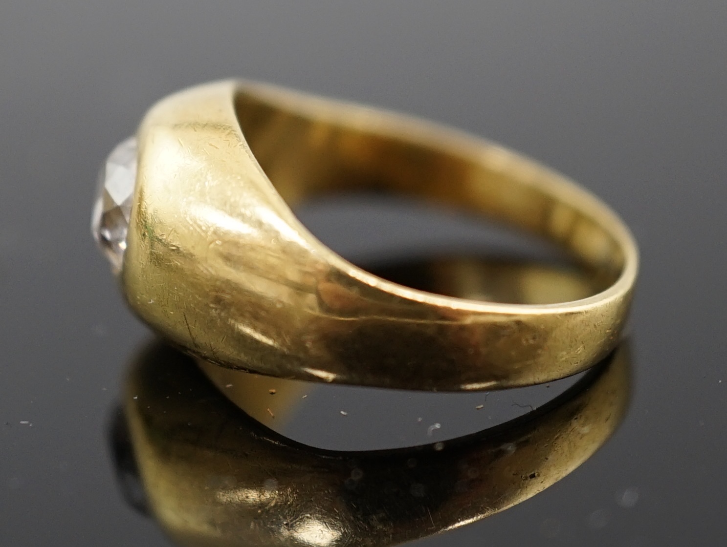 A gold and gypsy set old round cut diamond ring